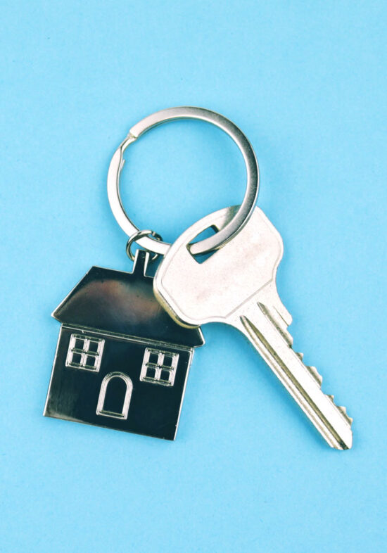 House and Key on a keychain on a light blue background